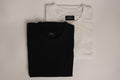 Folded black and white simple luxury goods heavyweight t-shirts with labels on a light gray background