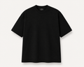 A black, slightly oversized, short-sleeve crewneck t-shirt laid flat against a light off-white background. A black woven label is visible inside the collar, reading 'Simple Luxury Goods'