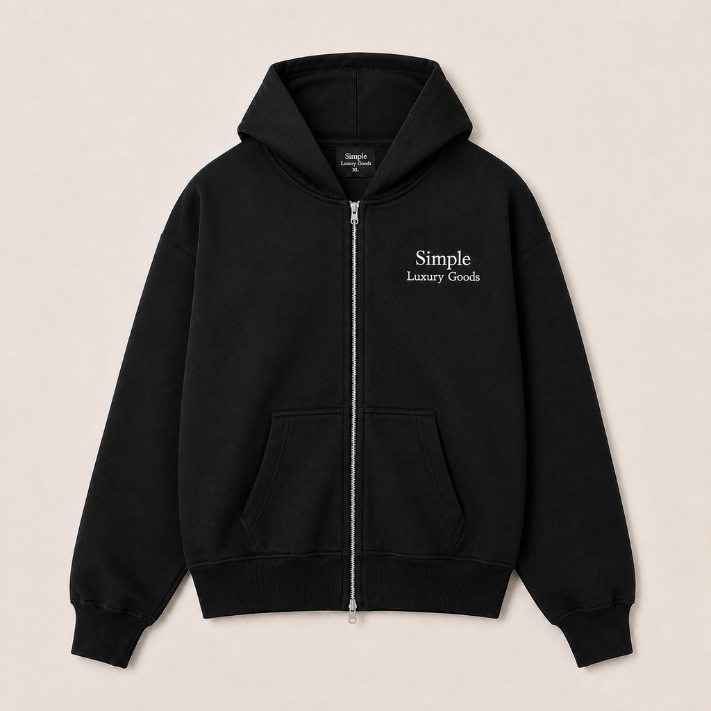 A heavyweight black double zip-up hoodie with a white embroidered logo reading 'Simple Luxury Goods' on the left chest, displayed flat against a light beige background.